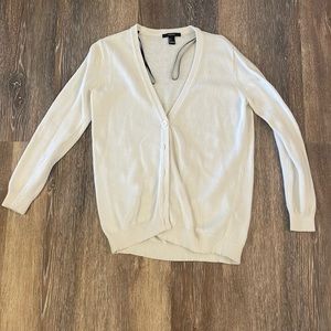 Cream cardigan sweater.